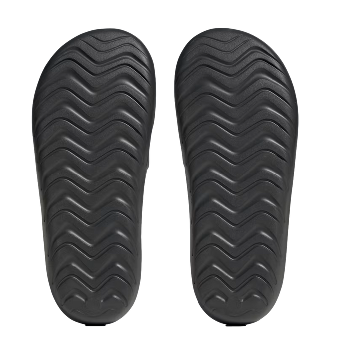 Top-down view of two black sandal soles with a wavy zigzag tread pattern, set against a plain white background.