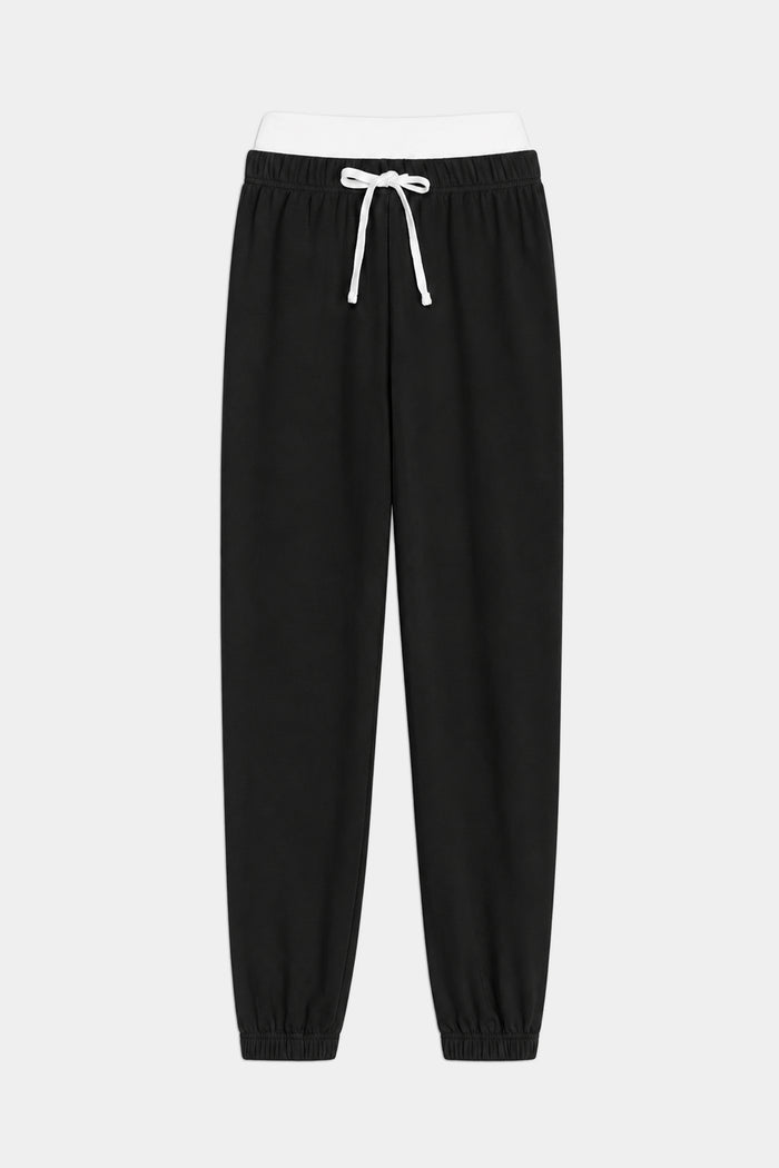 The SPLITS59 Andie Dual Waist Sweatpant in Black/White features a comfortable modal spandex blend, elastic waistband, white drawstring, and elastic cuffs, shown against a plain white background.