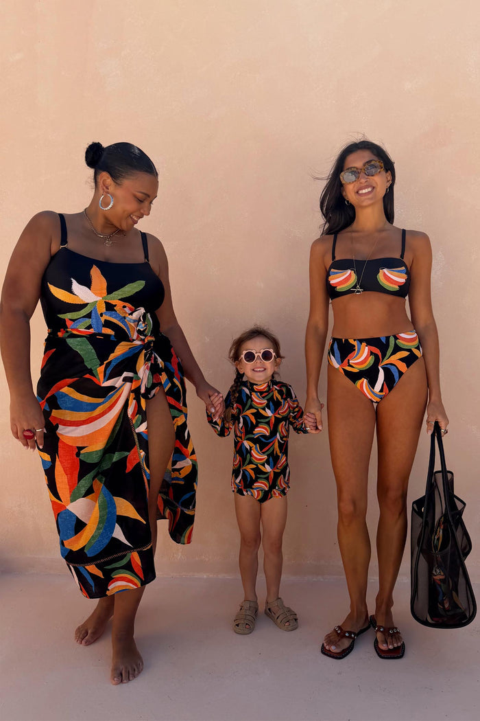 Banana Sarong in black cotton with a multi-colour banana print and wrap tie, styled for inclusive sizing.