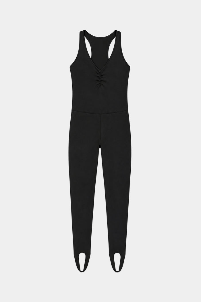 The Darci Airweight Stirrup Jumpsuit in black by SPLITS59 features a sleeveless design in a nylon-spandex blend, V-neckline, gathered front detail, fitted legs, and stirrup hems, shown laid flat on a white background.
