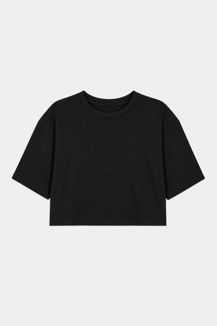 The SPLITS59 Djuna Oversized Crop Jersey Tee in black, made from a soft spandex blend, features short sleeves and is shown laid flat on a white background.