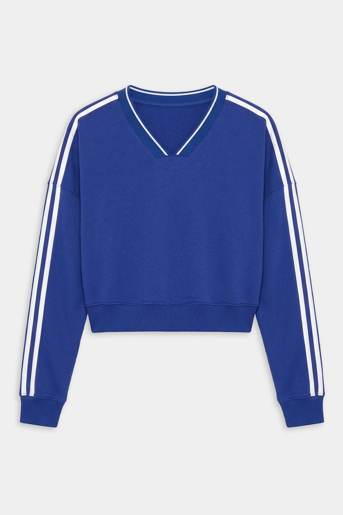 The SPLITS59 Ellie Fleece V Neck Sweatshirt in Cobalt/White features a cropped fit, long sleeves with white double stripes, and a V-neck collar—ideal for an athletic look.