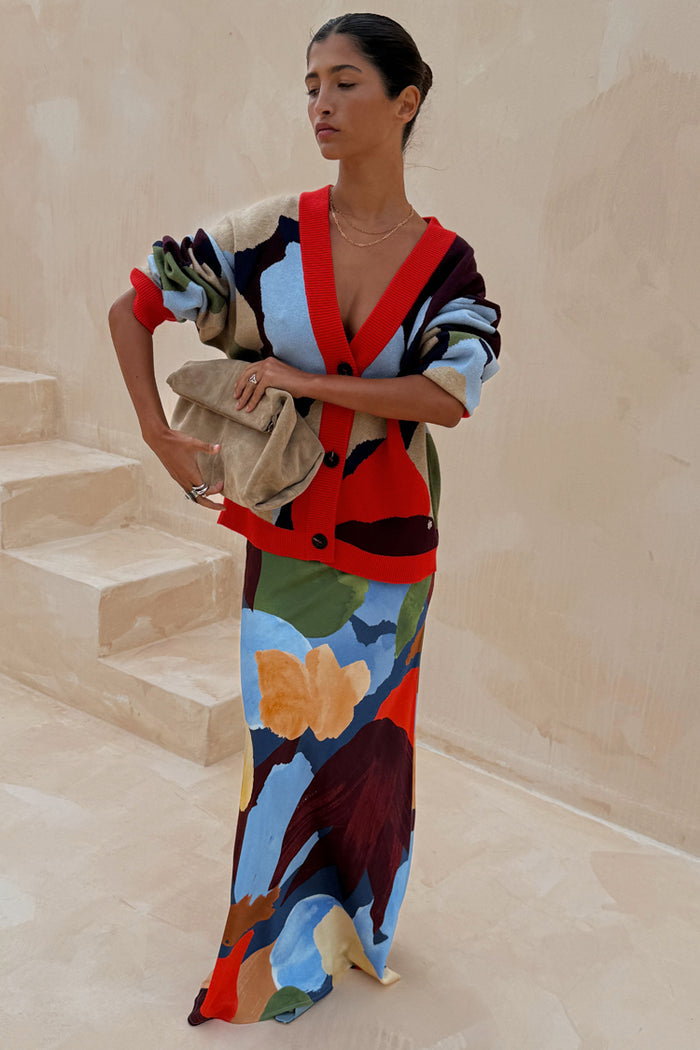 Navy Abstract Callie Cardigan with a colourful artist print and red trim, styled with a matching abstract maxi skirt.