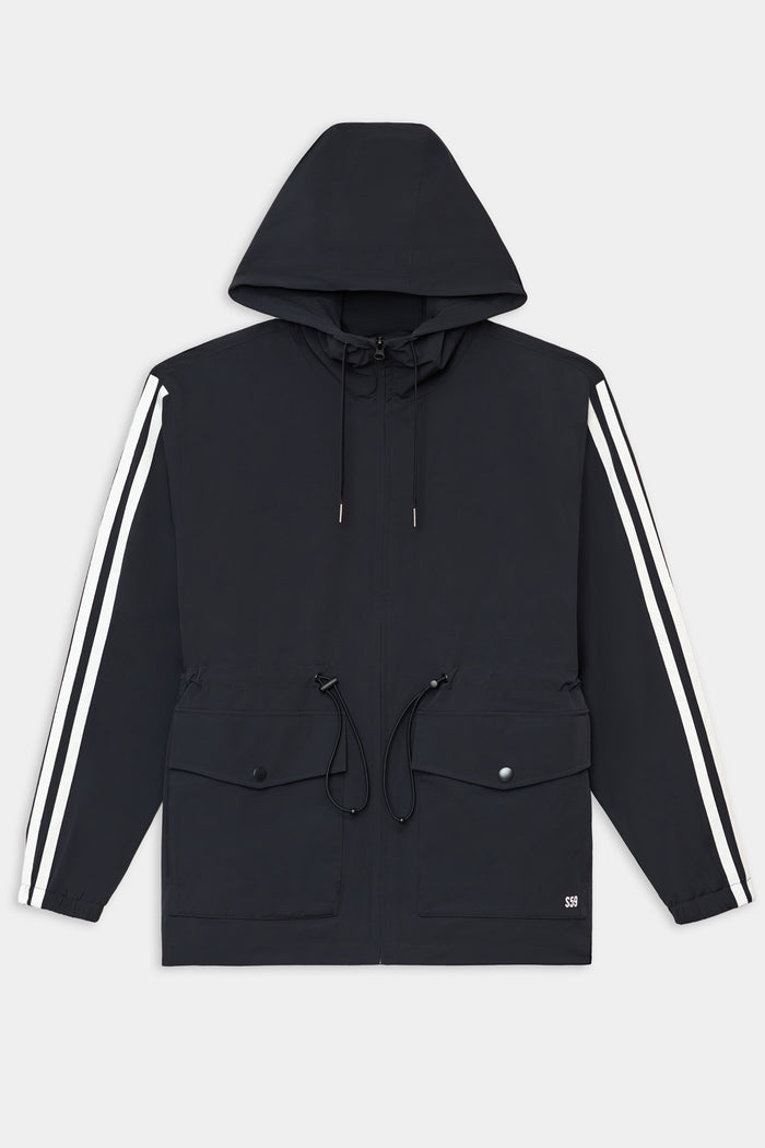 The SPLITS59 Reggie Water Repellent Jacket in Black/White features white sleeve stripes, front drawstrings, flap pockets, and a zip closure. Made from a nylon-spandex blend, it is shown laid flat on a white background.