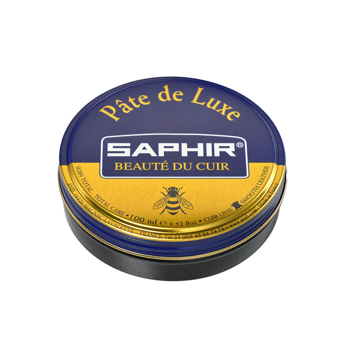 A tin of Saphir Pate de Luxe wax polish for shoes with a blue label and gold accents.