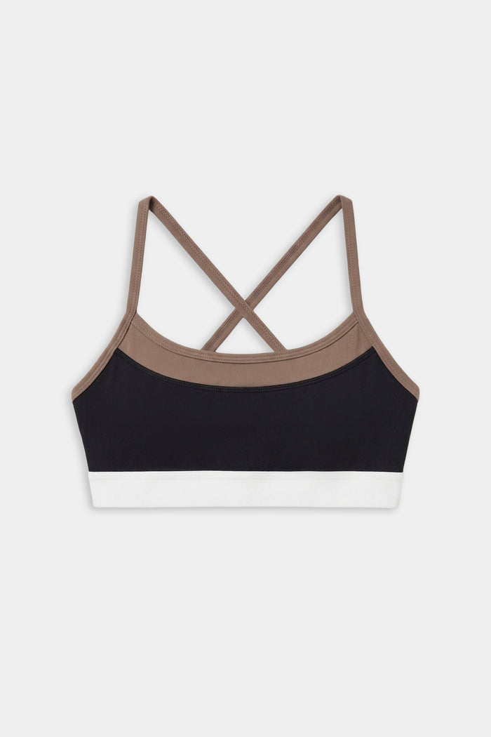 The SPLITS59 Scottie Airweight Bra - Black/Lentil features a color-blocked design with brown straps, a black front panel, and a white bottom band in soft nylon-spandex blend, shown on a white background.