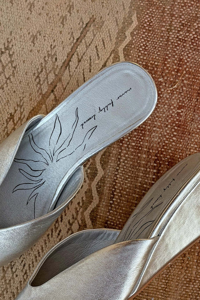 Silver Wedge Mule in metallic leather with a black sun illustration and branded script on the footbed.