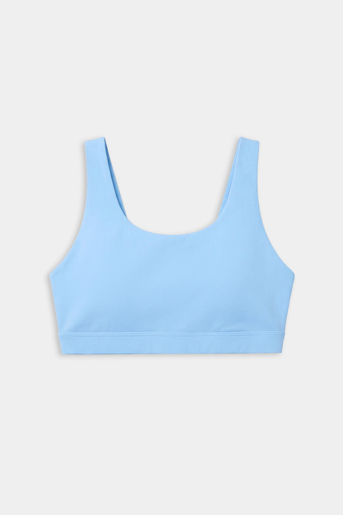 The SPLITS59 Sprint Rigor Bra in Skylight features a scoop neckline and wide straps, ideal for gym workouts and multi-sport performance, shown against a plain white background.
