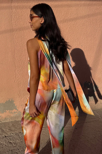 Abstract Lily Top featuring a vibrant multicoloured print and long tie neck fastenings draped over the shoulders.