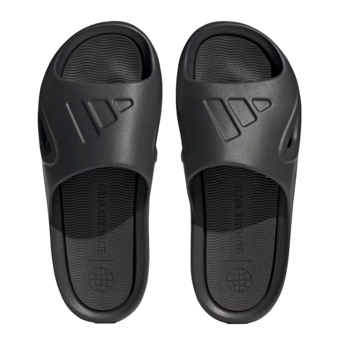 Top-down view of black Adidas slides with the embossed logo on the strap and "END PLASTIC WASTE" printed on the footbed.