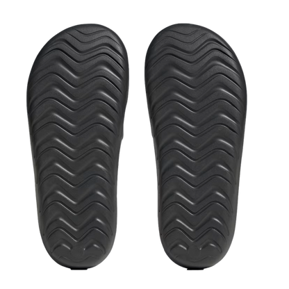 Top-down view of two black sandal soles with a wavy zigzag tread pattern, set against a plain white background.