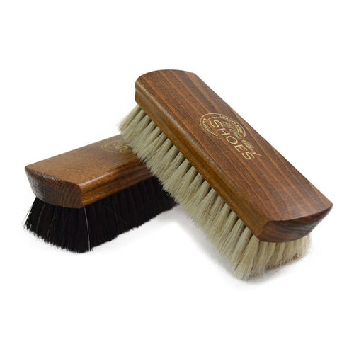 Two wooden shoe shine brushes with horsehair bristles, one with the brand 'AFPOS' visible on the top.