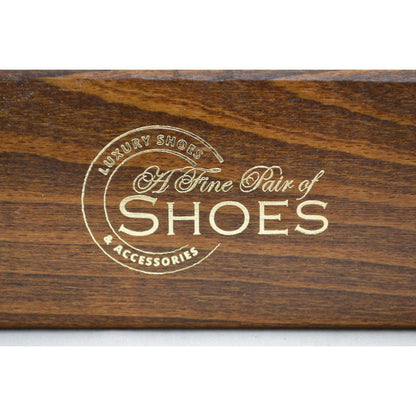 A wooden shoe shine brush with horsehair bristles, one with the brand 'AFPOS' visible on the top.