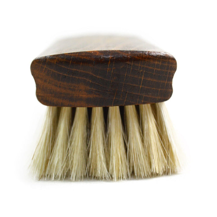 A wooden shoe shine brush with horsehair bristles, one with the brand 'AFPOS' visible on the top.
