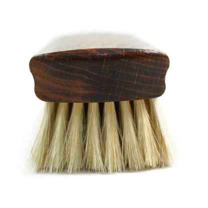 A wooden shoe shine brush with horsehair bristles, one with the brand 'AFPOS' visible on the top.
