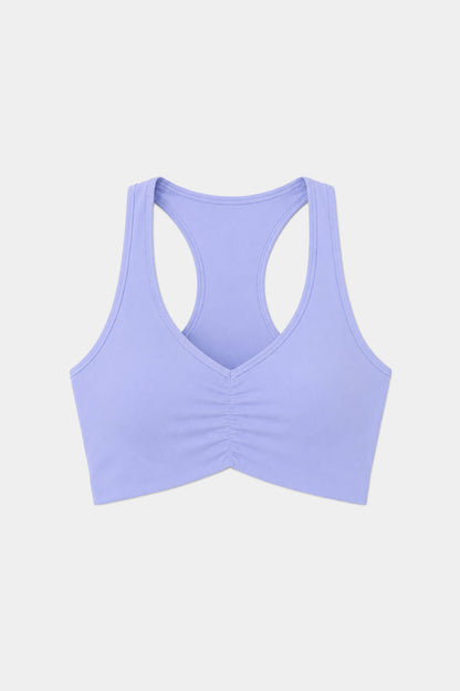 The SPLITS59 Airweight Bra with Ruching in Purple Haze features a racerback design and front ruching, crafted from a soft nylon-spandex blend, shown against a plain white background.