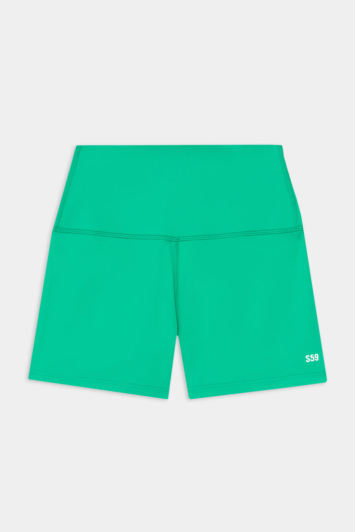 The SPLITS59 Airweight High Waist 3.5” Short in Spearmint features a green, fitted design in a smooth nylon-spandex blend with a small white "S59" logo on the lower left leg.