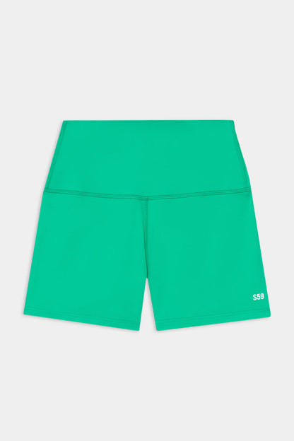 The SPLITS59 Airweight High Waist 3.5” Short in Spearmint features a green, fitted design in a smooth nylon-spandex blend with a small white "S59" logo on the lower left leg.