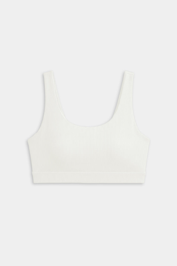 The SPLITS59 Airweight Rib Bra in white features wide straps and a scoop neckline, crafted from ribbed airweight fabric for comfort—ideal for hot yoga. Shown laid flat on a plain light background.