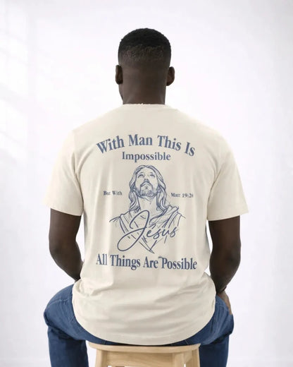 Man wearing a t-shirt with a Jesus illustration and text on the back, sitting on a stool against a white background.