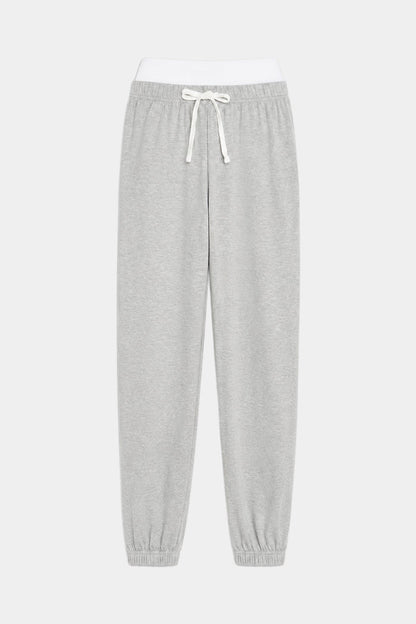 The SPLITS59 Andie Dual Waist Sweatpant in Heather Grey/White features a soft modal spandex blend, white elastic waistband, white drawstring, and elastic cuffs, shown laid flat on a plain background.