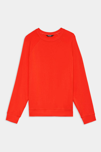 The SPLITS59 Andie Oversized Fleece Sweatshirt in Lotus Red, a long-sleeved crewneck pullover made in Los Angeles, is shown laid flat on a white background.