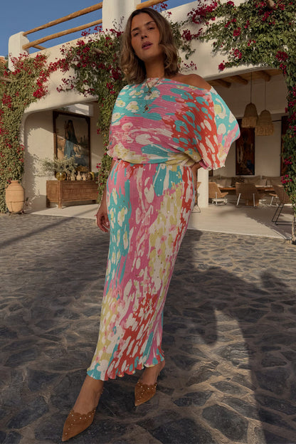 Animal Print Tilly Dress with metallic flecks and voluminous top, shown on a model in a sunlit outdoor setting.