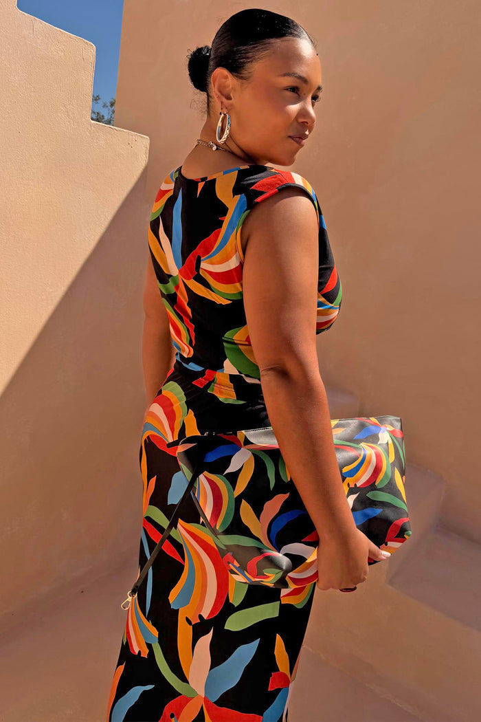 Banana A-Symmetric Top and Dorris skirt co-ord with multicoloured banana print on black jersey, showcasing inclusive sizing.