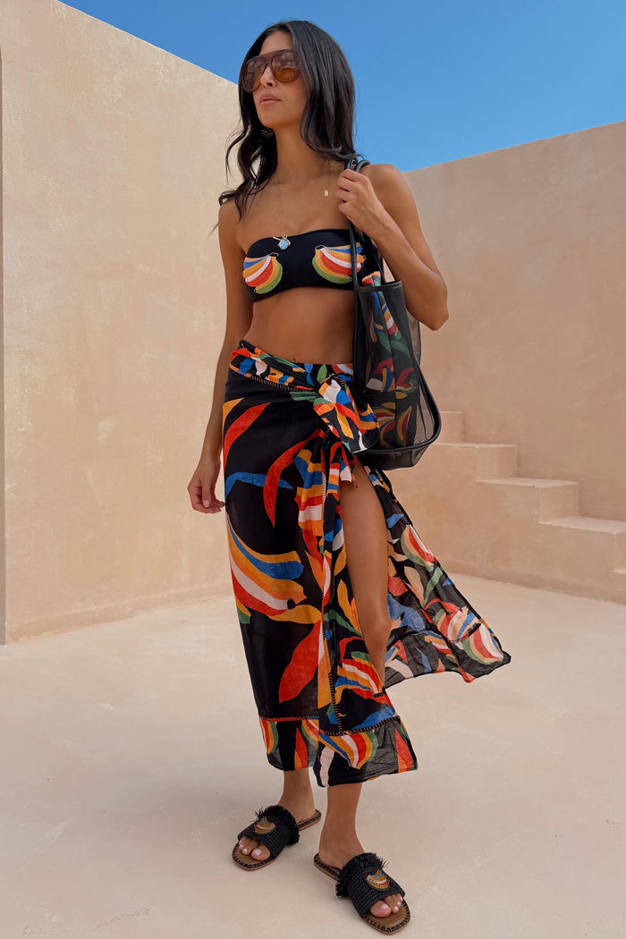 Multi-wear Banana Sarong in sheer black cotton with a multi-colour print, ideal for vacation layering.