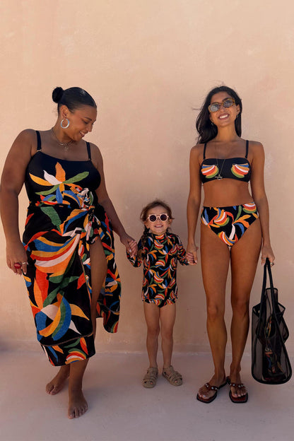 Banana Sarong in black cotton with a multi-colour banana print and wrap tie, styled for inclusive sizing.