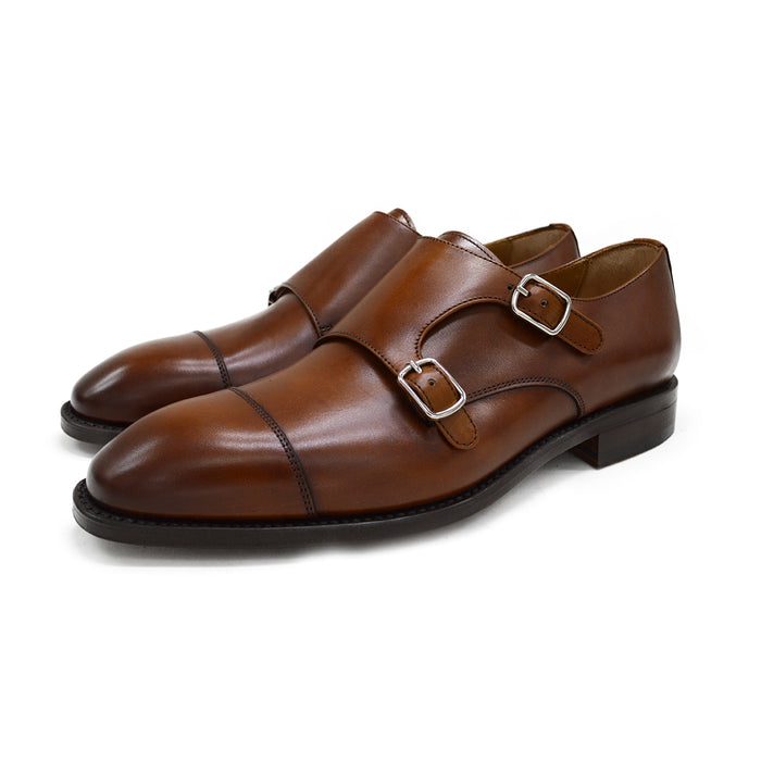 A brown Berwick 1707 double monk shoe with double buckle monk strap on a white background.