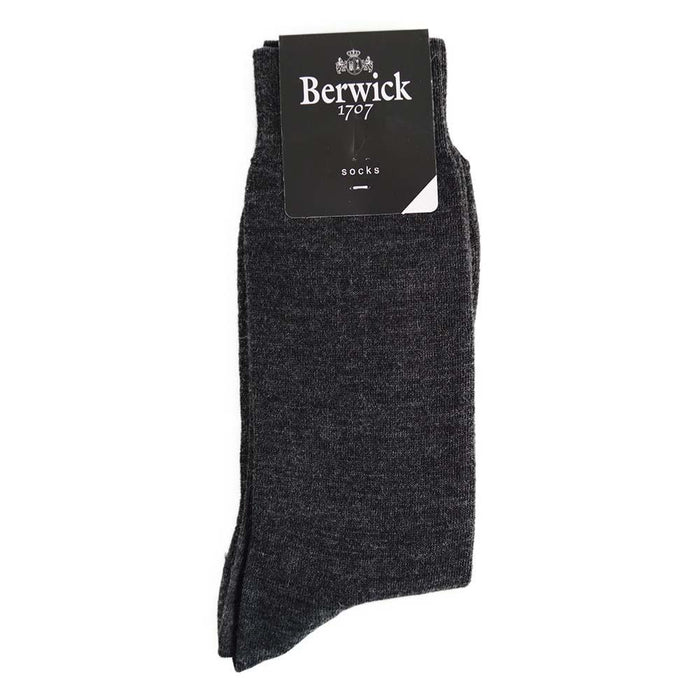 A pair of grey plain knit socks with the Berwick 1707 brand tag visible.