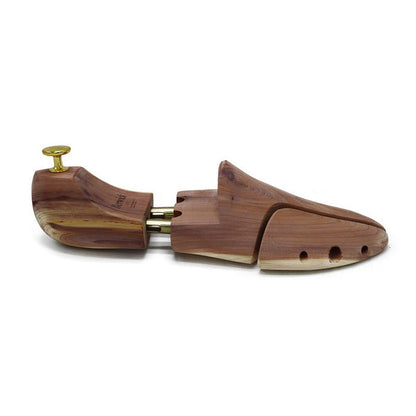 A Berwick 1707 cedar wood shoe tree with brass fitments, displayed in an open position showing the interior structure.