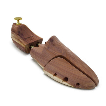 A Berwick 1707 cedar wood shoe tree with brass fitments, displayed in an open position showing the interior structure.