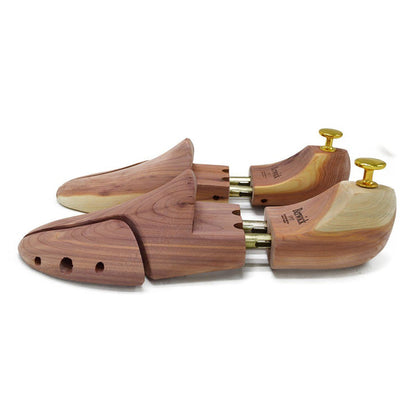 A Berwick 1707 cedar wood shoe tree with brass fitments, displayed in an open position showing the interior structure.