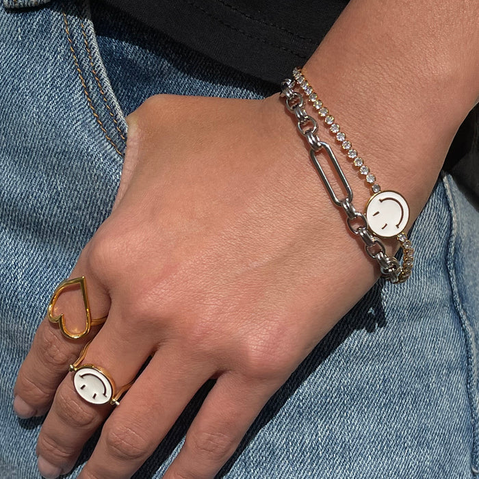 Bespoke silver link chain bracelet with a T-bar closure, styled on a wrist with stacked rings and denim.