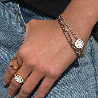 Bespoke silver link chain bracelet with a T-bar closure, styled on a wrist with stacked rings and denim.
