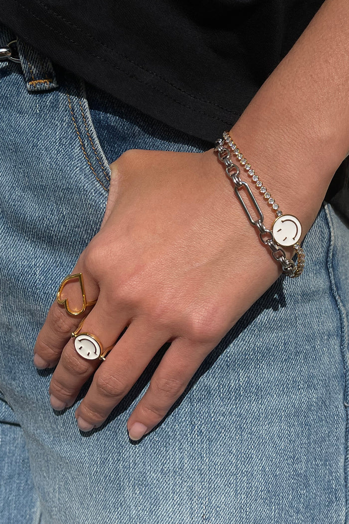 Silver Bespoke Chain Bracelet with T-bar closure styled with other jewellery against denim.