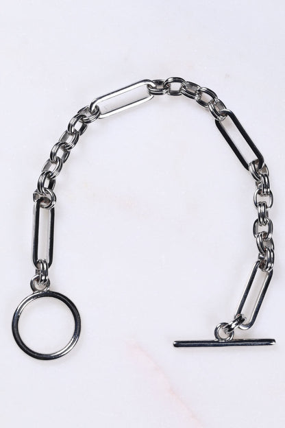 Silver Bespoke Chain Bracelet with a T-bar closure and elegant links on a white marble surface.