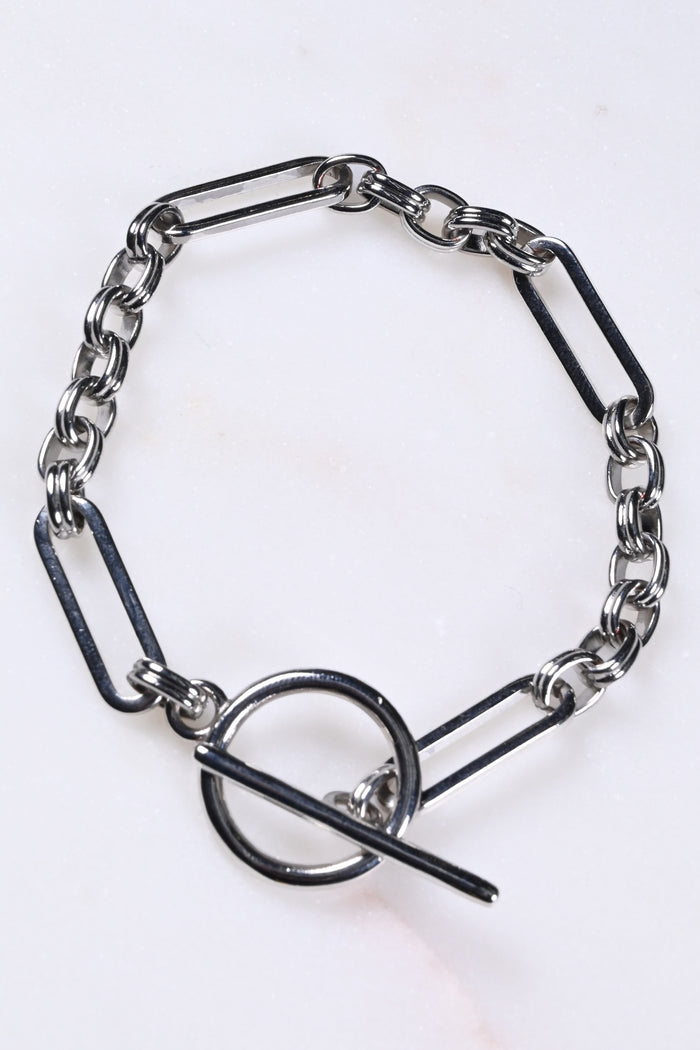 Bespoke silver chain bracelet with mixed links and a T-bar fastening.