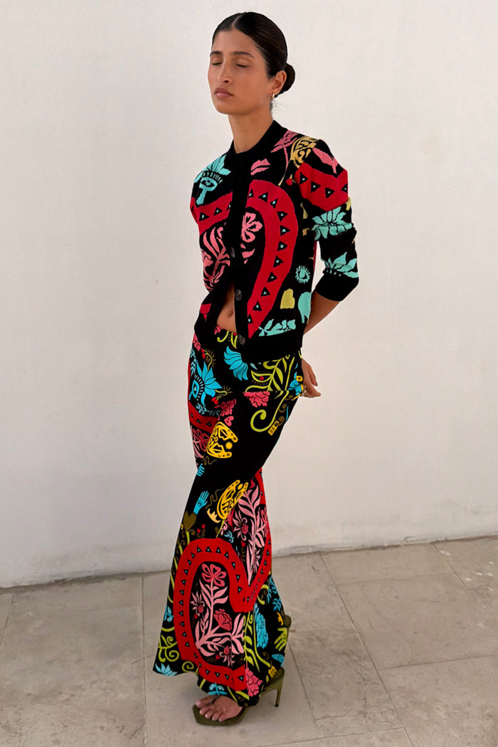 Black Amara Dorris Skirt with vibrant hand-painted heart and eye motifs, styled with a matching cardigan.