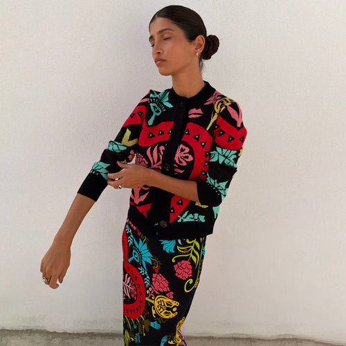 Black Amara Hollie Cardigan in a slim fit knit with hand-painted eye and heart motifs on a model.
