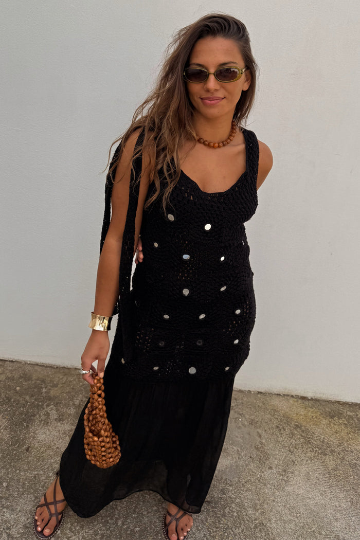 Black Alicia Dress featuring a crochet bodice with silver sequins and a gathered chiffon skirt on a model.