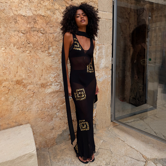 Black & Gold Simona Sequin Maxi Dress featuring sheer mesh, gold square motifs and a multi-wear scarf.