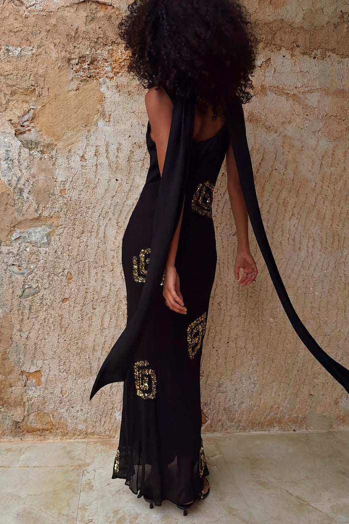 Black and Gold Simona Sequin Maxi Dress featuring gold motifs and a multi-wear detachable scarf.
