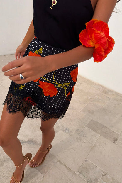 Black Poppy Mini Maeva Skirt featuring the iconic poppy print, white polka dots and black lace trim.