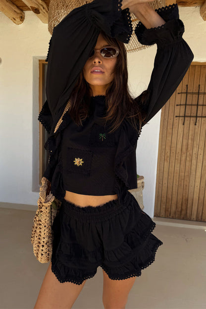 Black Ruffle Shorts and matching Isla top co-ord with lace trim, tiered ruffles and embroidered sun and palm motifs.