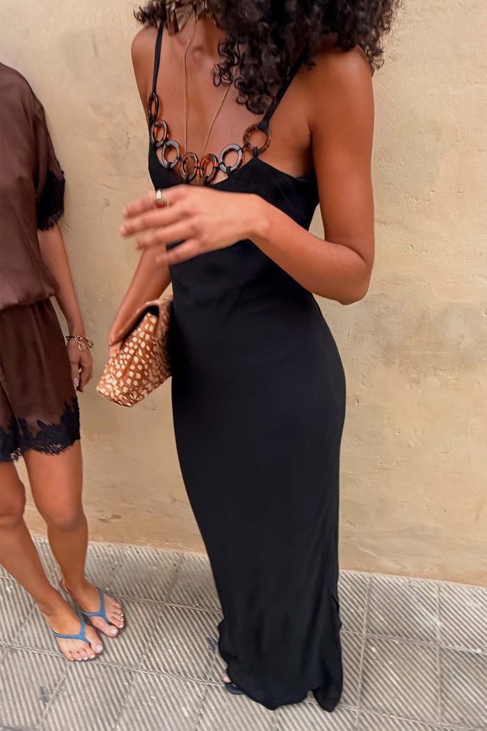 Black Sapna maxi dress featuring a sleek fitted silhouette and tortoise-shell ring detailing across the neckline.
