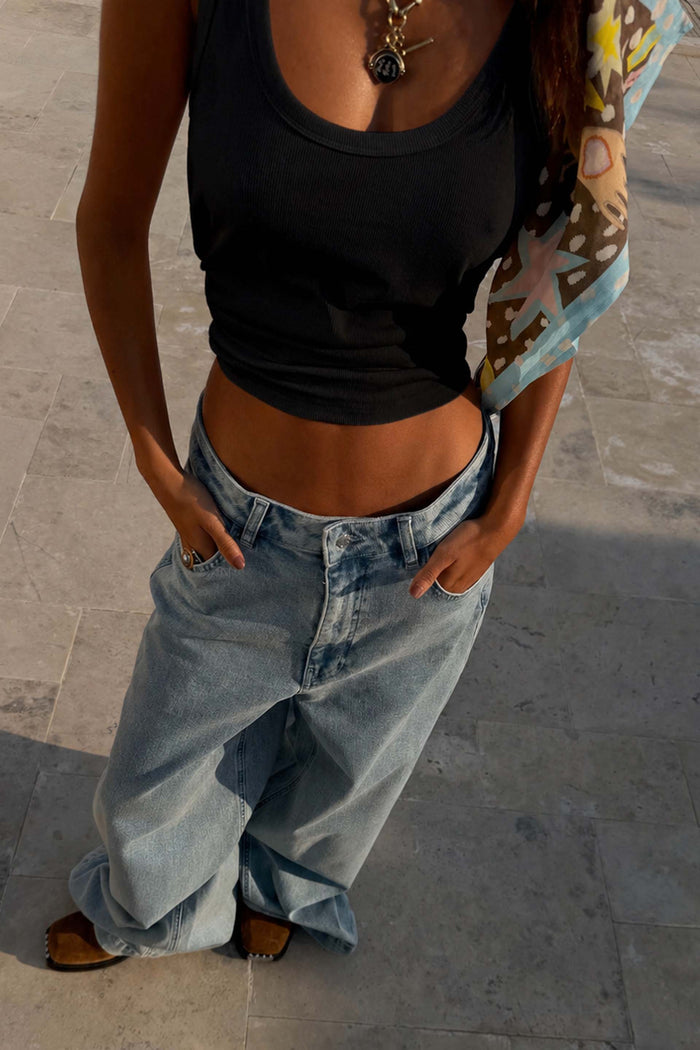 Black Scoop Neck Rib Tank in soft stretch ribbed fabric styled with baggy denim for a casual London look.