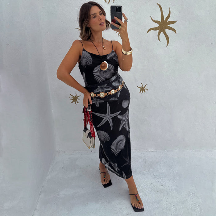 Black Seashell Mesh Cami Dress with white shell and starfish prints, styled with a gold belt in a mirror selfie.
